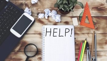 Help text on the Notepad, flower, telephone, magnifier, pencils on the table