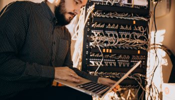 young-it-service-man-repairing-computer